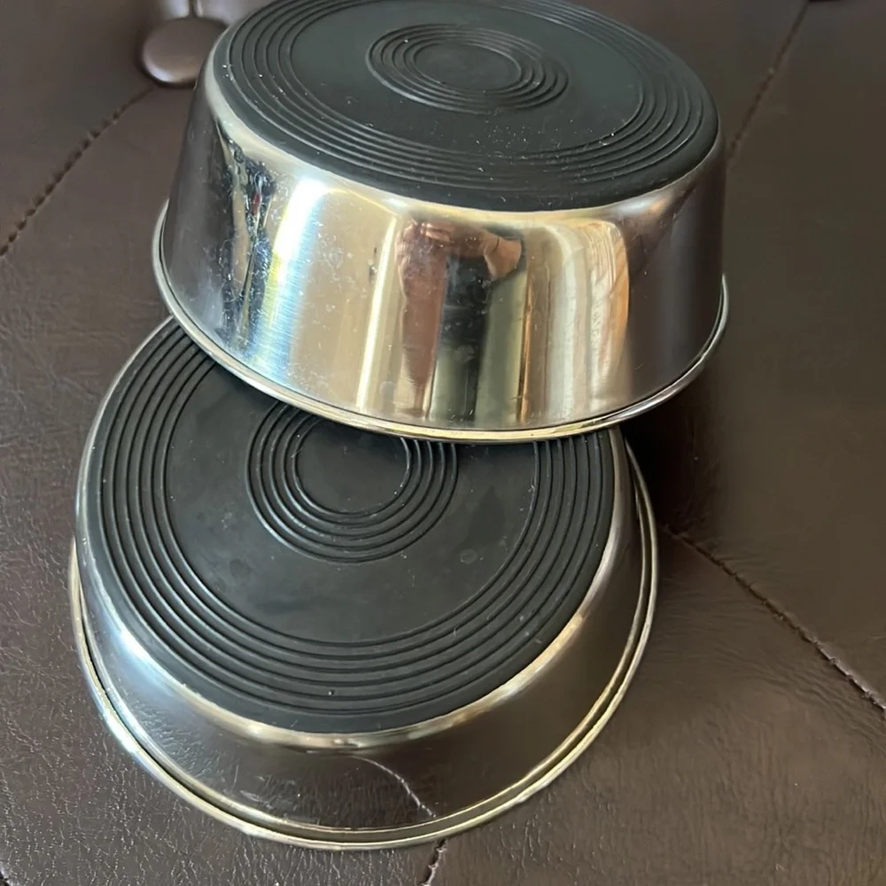 Pre-owned set of two cat food bowls, outside of bowl is stainless steel.